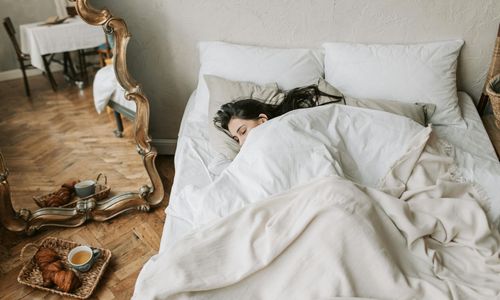 A calm and tidy bedroom with soft lighting, ready for sleep.