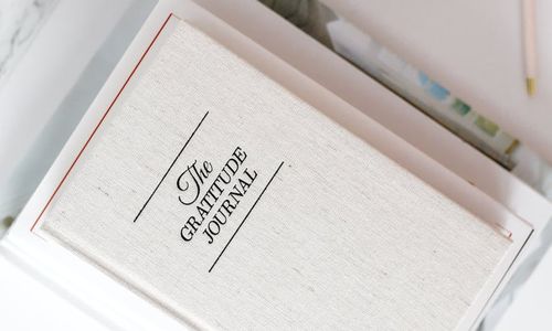 A clean desk with only a notebook and a pen, symbolizing focus.